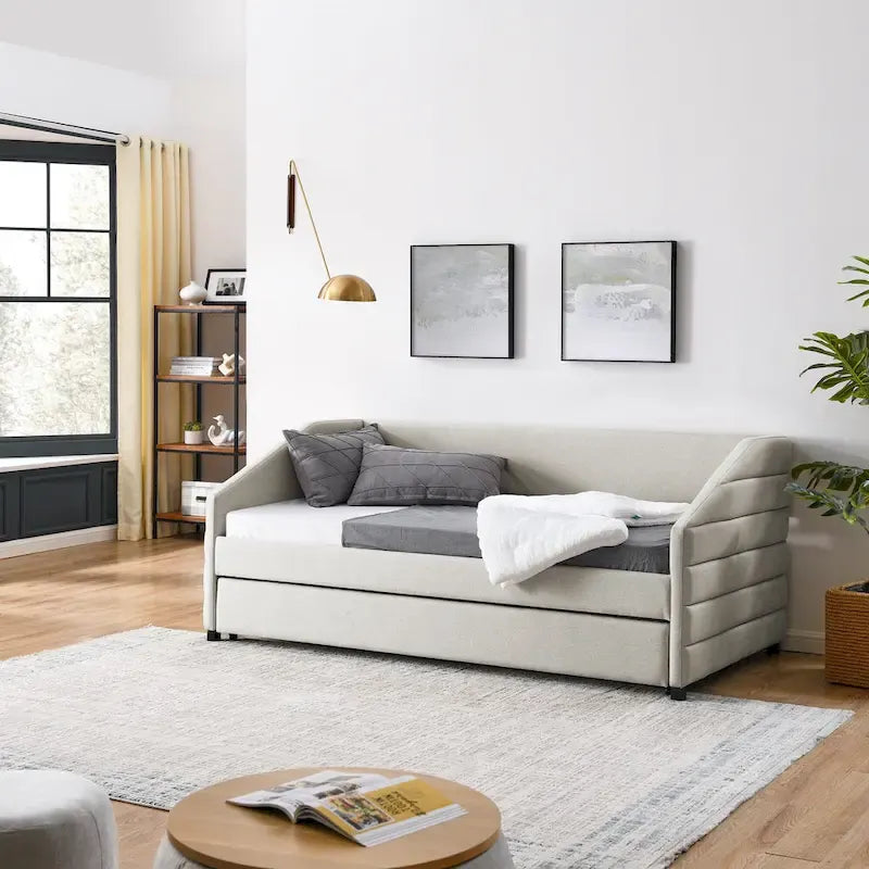 Lit de repos beige à dossier ailé en lin capitonné, avec lit gigogne escamotable